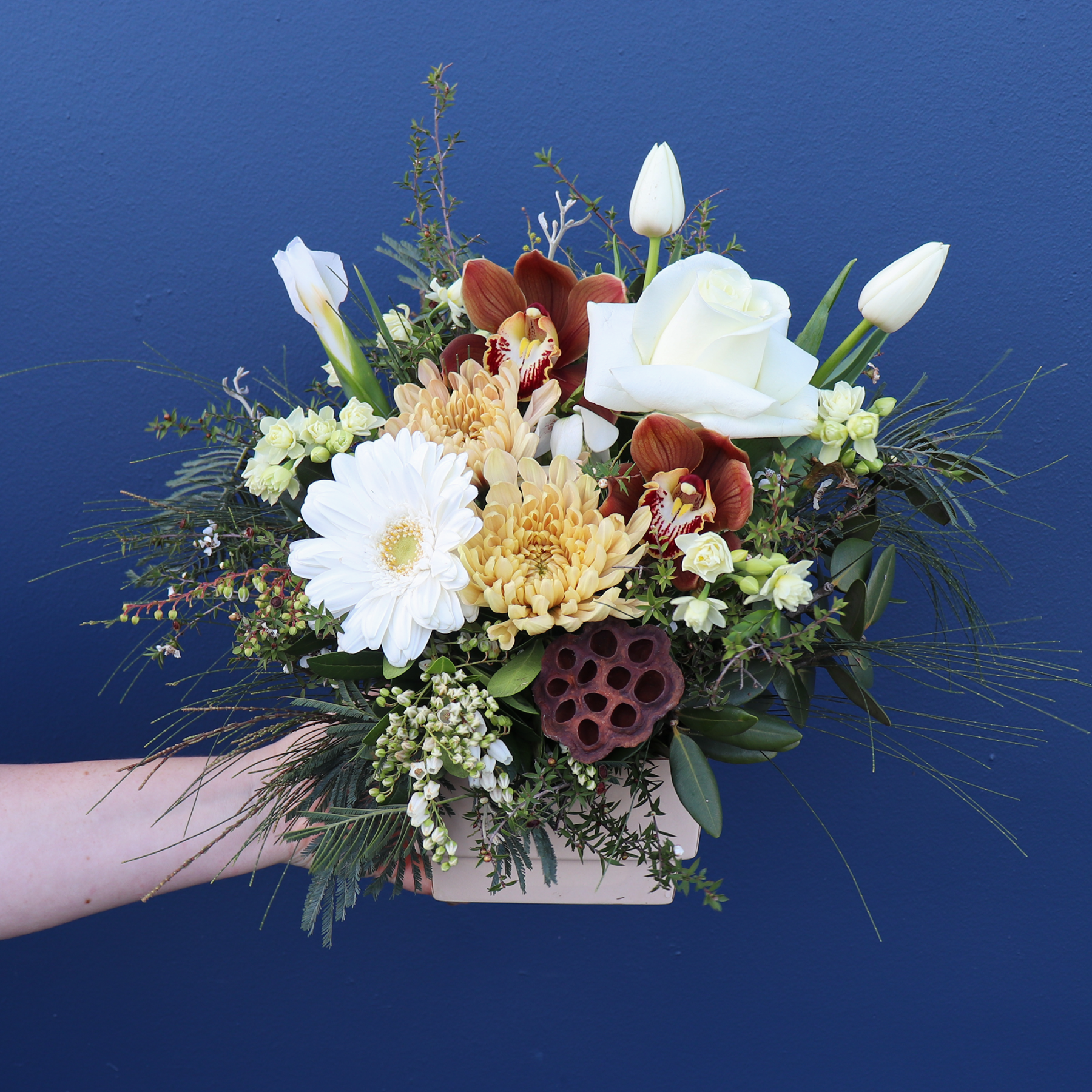 Small Beautiful White and Green Flower Arrangement held by a Florist