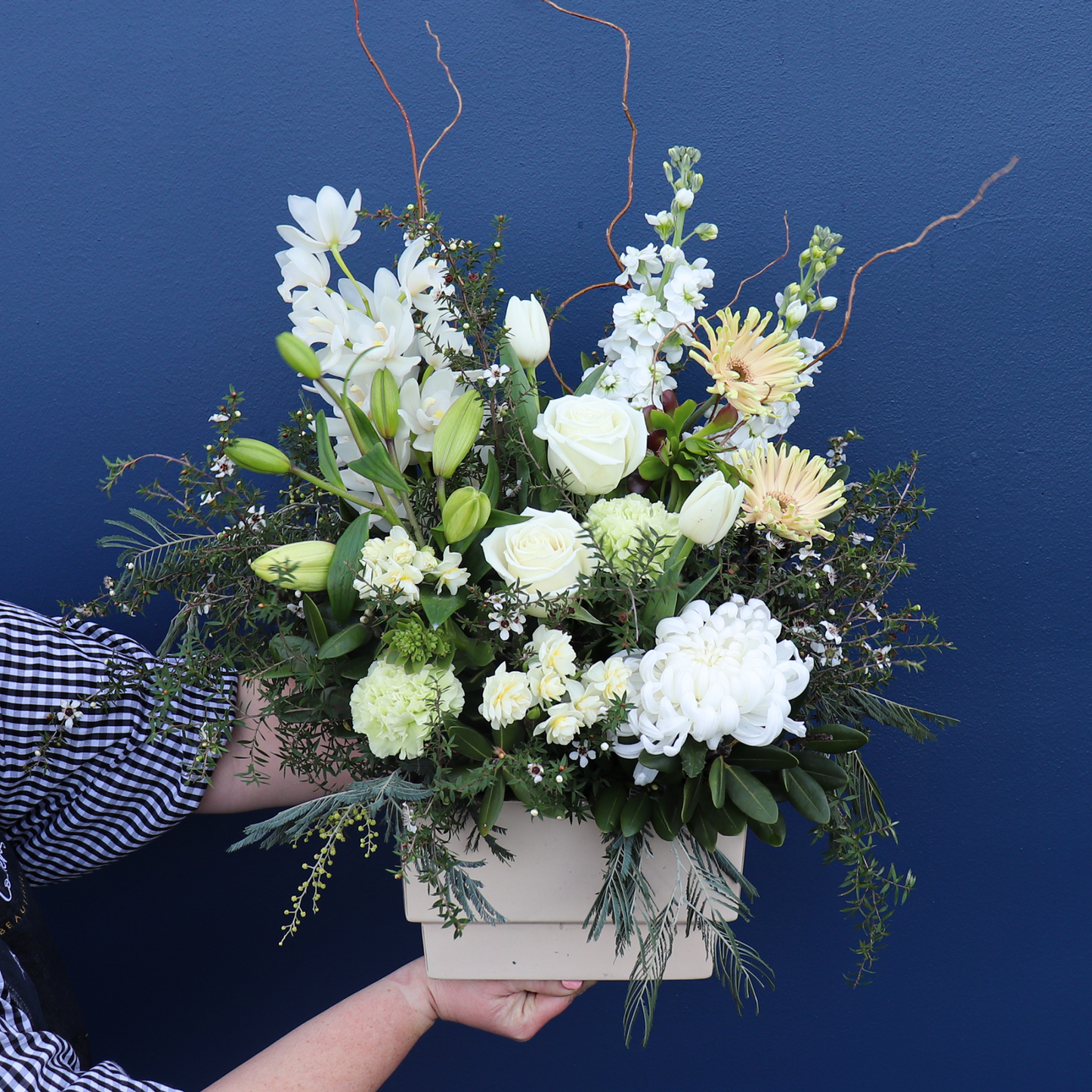 Fabulous Sized Beautiful White and Green Flower Arrangement held by a Florist