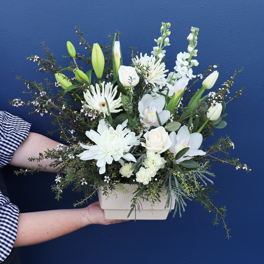Beautiful White and Green Flower Arrangement held by a Florist